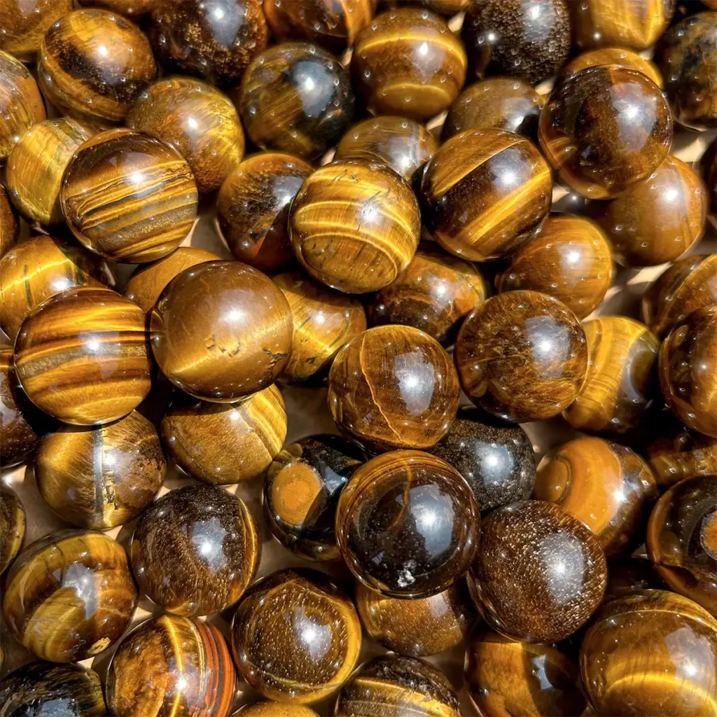 Tiger’s Eye crystals displaying golden-brown patterns, symbolizing strength and grounding Earth Element energy.