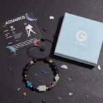 Top-down view of the aquarius birthstone bracelet on a dark background showing all 6 natural stones.