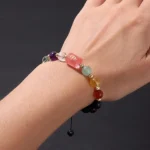 Close-up of an aries birthstone bracelet featuring vibrant red jasper and deep garnet beads.