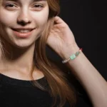 Top view of the cancer birthstone bracelet on a dark background showing all natural birthstones.