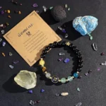 gemini crystal bracelet flat lay with natural crystals and stones