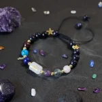 Aquarius birthstone bracelet surrounded by raw Amethyst and Lapis Lazuli crystals for energy balance.