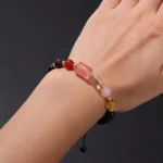 Close-up of a leo birthstone bracelet featuring golden Tiger's Eye and Sunstone beads on a wrist.