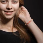 Full view of the leo birthstone bracelet on a dark background showing the complete natural stone sequence.