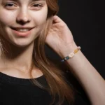 Full top-down view of the libra birthstone bracelet on a dark background showing the complete bead layout.