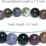 Close-up of moss agate beads showing detailed natural patterns that resemble organic landscapes and textures.