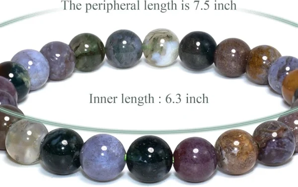 Close-up of moss agate beads showing detailed natural patterns that resemble organic landscapes and textures.