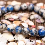 natural k2 azurite bracelet close up blue spotted beads shell background
