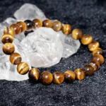 tiger eye bracelet natural stone 8mm beads on crystal background