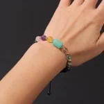 Close-up of a scorpio birthstone bracelet featuring deep Black Obsidian and forest green Malachite beads on a wrist.