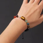 Close-up of a taurus birthstone bracelet featuring forest green Aventurine and soft Rose Quartz beads on a wrist.