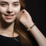 A smiling woman wearing a virgo crystal bracelet for mindful focus and emotional balance.