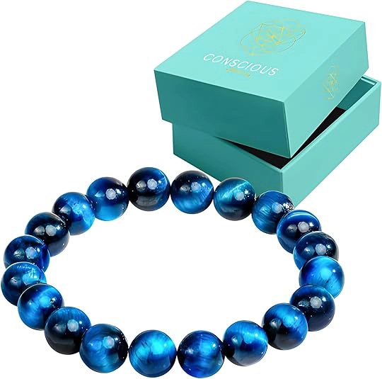Blue glass bead bracelet placed in front of a turquoise Conscious jewelry box.