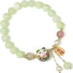 good luck bracelet for women with green beads and lucky cat pendant