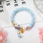 light blue bead bracelet with floral background soft aesthetic jewelry