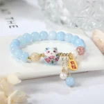 light blue bead bracelet styled on table with soft aesthetic background