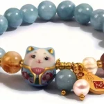 lucky charm bracelet for women cat charm detail blue beads close up