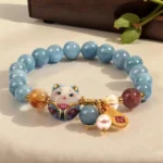 lucky charm bracelet for women with blue beads and ceramic cat pendant