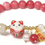 red lucky charm bracelet with glossy beads and cat pendant