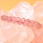 strawberry quartz bracelet pink beads on crystal background